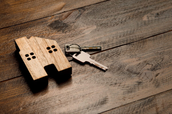 House keys and home model representing legal help in Oklahoma from an Oklahoma Estate Lawyer for estate planning, probate, and real estate matters